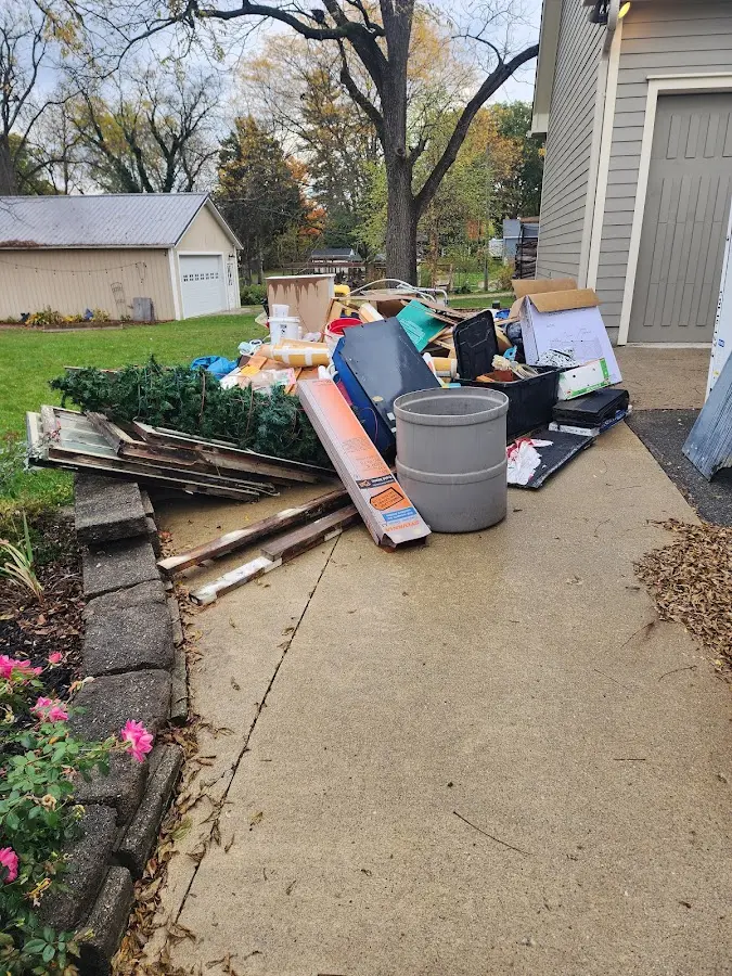 Dumpster being loaded with debris for 10 Yard Dumpster Rental in New Albany